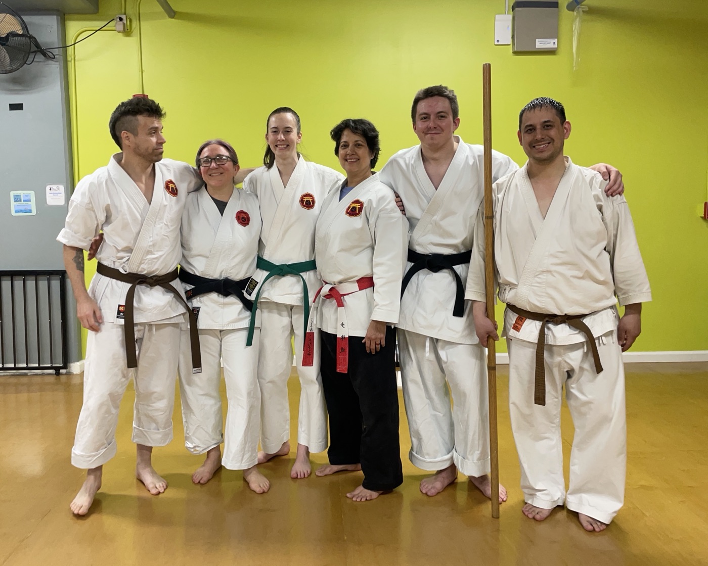 Class group in the dojo, one holding a bo