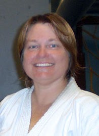 Deb Lee Sensei in a white karate gi