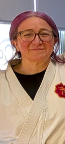 Jen Collins Sensei in a white karate gi